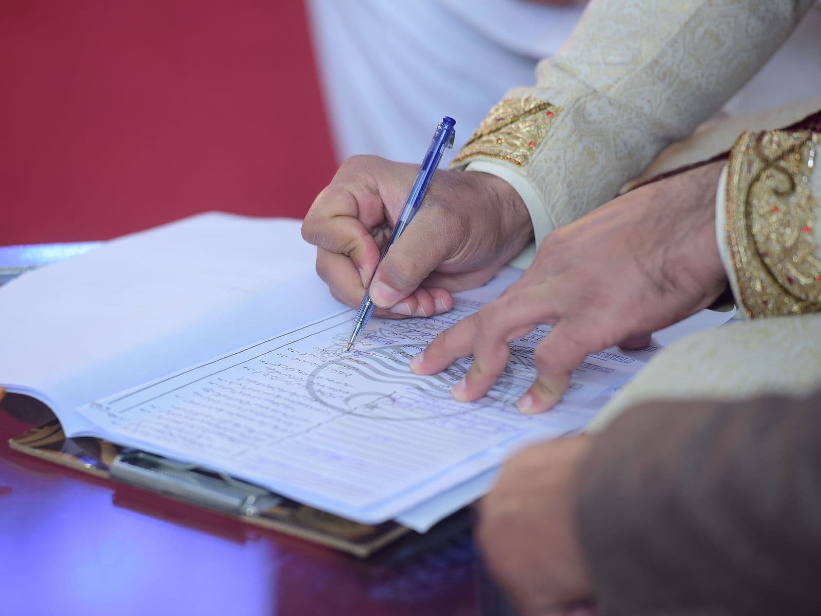 A groom signing the nikah marriage contract